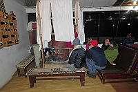 In the evening, people gathered around the stove in the dining room to get some heat.