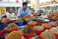 Nuts salesman in the local market in Bukhara.