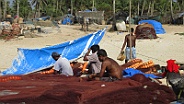 Fishermen mend their nets in Colva