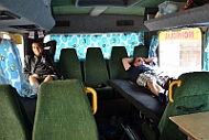 Alex and Ingo rests at the back of the bus.