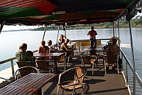We leave on a sunset tour on the Zambezi River with free drinks.