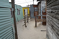 Then we went into the small passages between the houses made ​​of corrugated sheet sheds to the next woman.