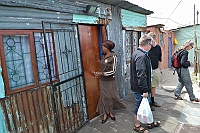 Here is the woman in front of her home in Khayelitsha.